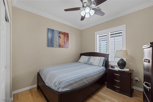 bedroom featuring ceiling fan, baseboards, light wood-style flooring, and ornamental molding