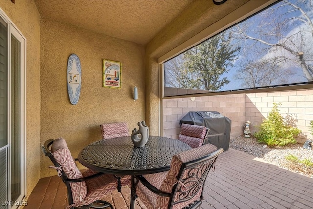 view of patio featuring grilling area and fence