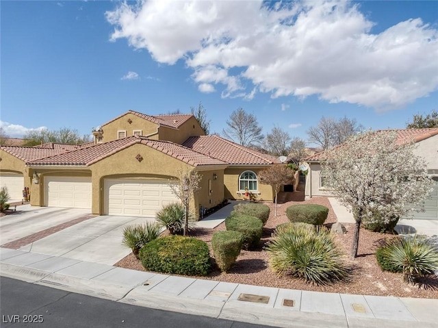 mediterranean / spanish house with stucco siding, driveway, a tile roof, and a garage