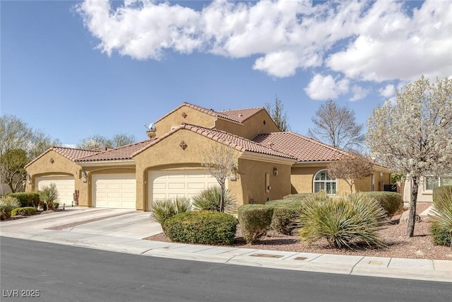 mediterranean / spanish-style home with a garage, a tile roof, driveway, and stucco siding