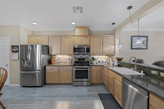 kitchen with visible vents, backsplash, light brown cabinets, stainless steel appliances, and a sink