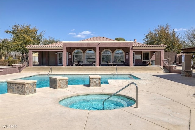 pool featuring a patio area and a hot tub