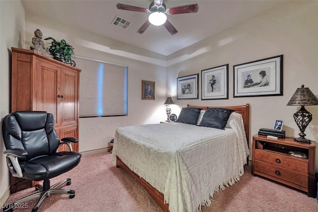 carpeted bedroom featuring ceiling fan, visible vents, and baseboards