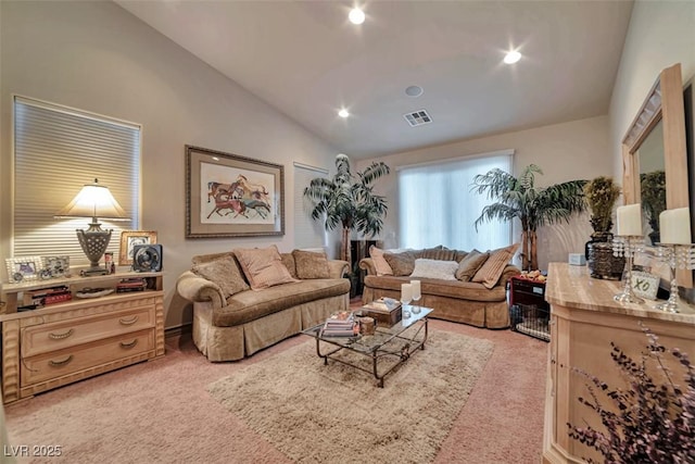 living room featuring vaulted ceiling, recessed lighting, visible vents, and light colored carpet