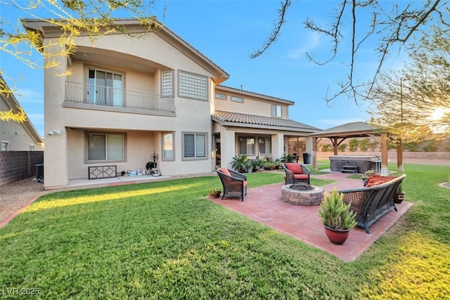 rear view of house featuring a patio, fence, a gazebo, stucco siding, and a hot tub