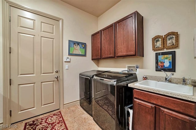 washroom featuring cabinet space, light tile patterned floors, a sink, and washing machine and clothes dryer