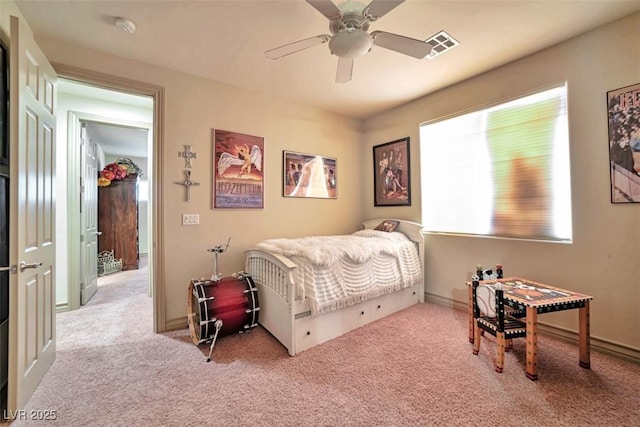 carpeted bedroom with ceiling fan, visible vents, and baseboards