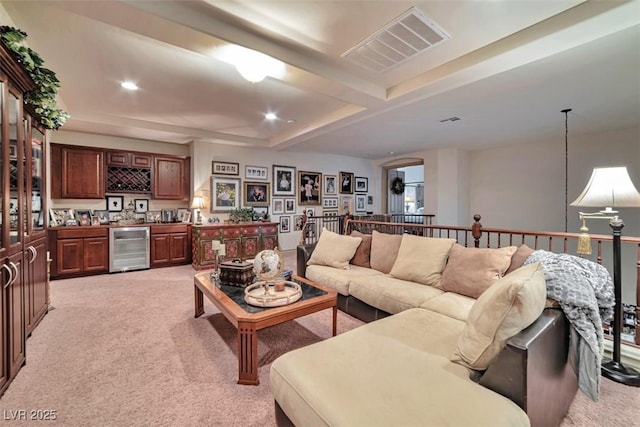 living area with wine cooler, indoor wet bar, recessed lighting, visible vents, and light carpet