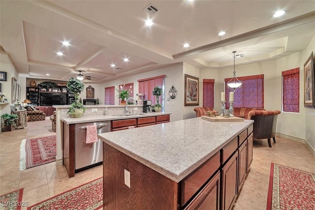 kitchen featuring a center island, open floor plan, dishwasher, and a sink