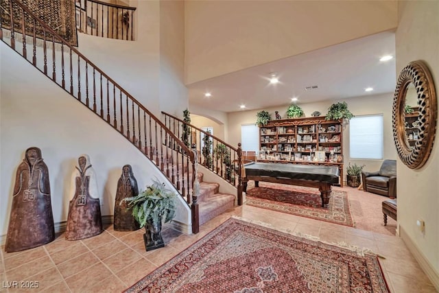 tiled foyer entrance featuring baseboards, visible vents, stairway, a high ceiling, and recessed lighting