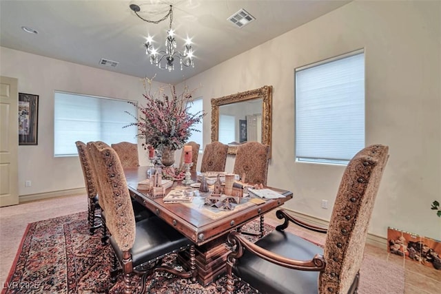 dining area featuring visible vents and a chandelier