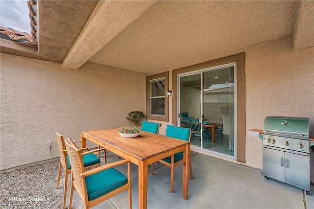 view of patio / terrace featuring outdoor dining space and a grill