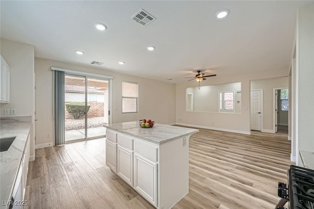 kitchen with light wood-style flooring, visible vents, and recessed lighting