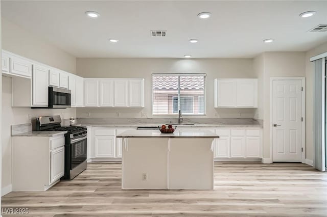 kitchen featuring light wood finished floors, visible vents, appliances with stainless steel finishes, white cabinetry, and recessed lighting