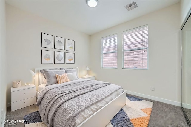 bedroom with carpet flooring, visible vents, and baseboards