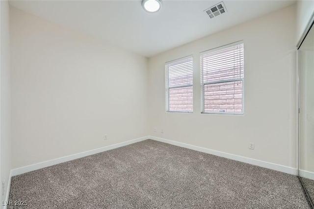 unfurnished bedroom featuring a closet, carpet, visible vents, and baseboards