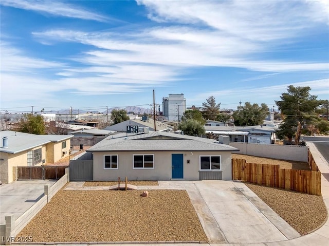 ranch-style home with fence and stucco siding