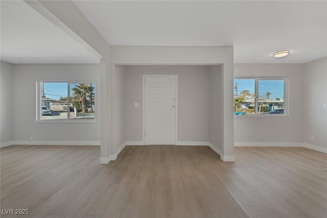 entrance foyer featuring baseboards and a wealth of natural light