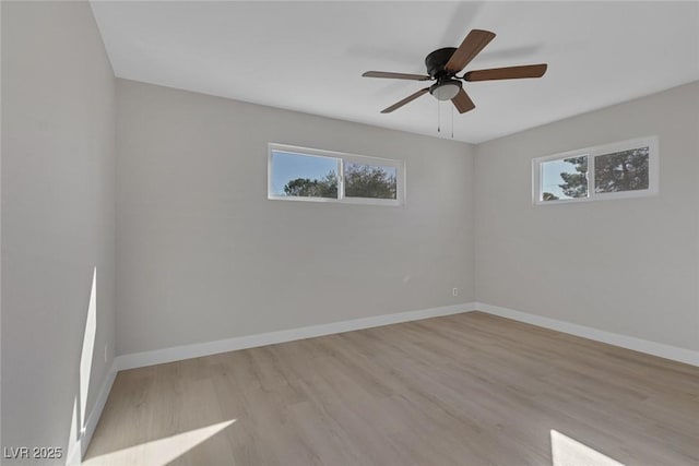 unfurnished room with a ceiling fan, baseboards, and wood finished floors