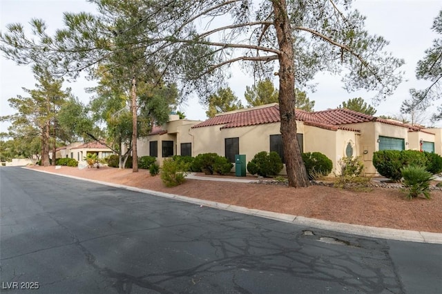 mediterranean / spanish-style house with a tiled roof and stucco siding