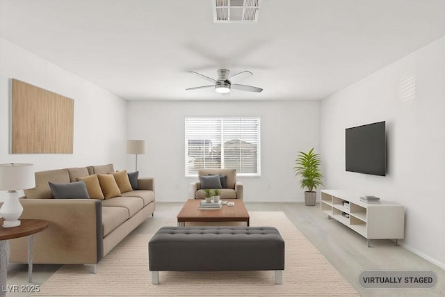 living room with a ceiling fan, visible vents, and baseboards