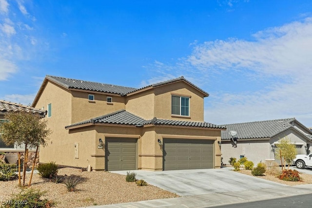 mediterranean / spanish house featuring driveway, a tiled roof, an attached garage, and stucco siding