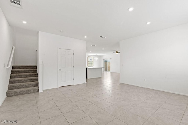 spare room featuring stairway, ceiling fan, visible vents, and recessed lighting