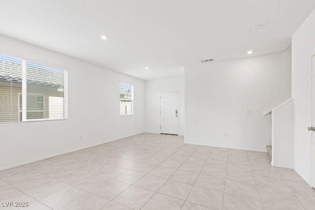 unfurnished room with stairway, visible vents, and recessed lighting