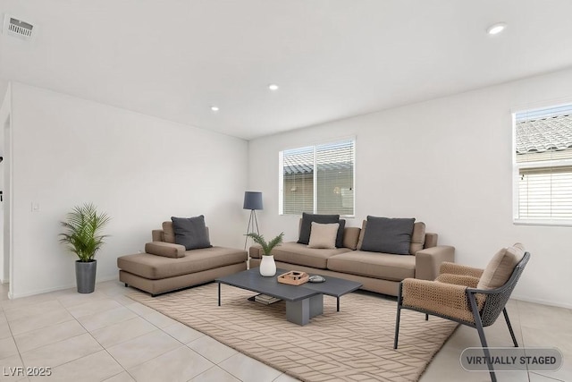 living area featuring light tile patterned floors, visible vents, and recessed lighting