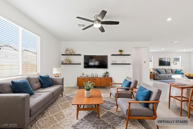 living area with a ceiling fan, recessed lighting, visible vents, and light wood-style floors