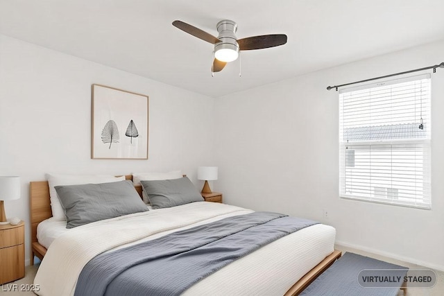 bedroom with baseboards and a ceiling fan