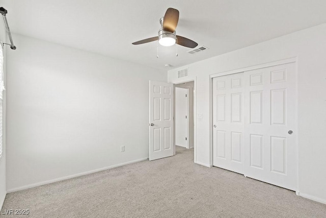 unfurnished bedroom featuring a closet, carpet flooring, visible vents, and baseboards