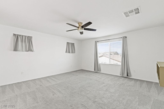 empty room with ceiling fan, carpet, and visible vents