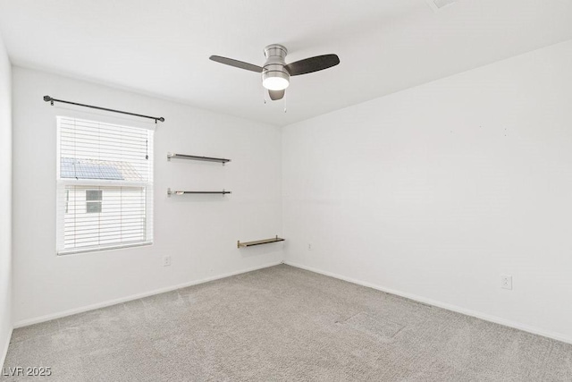 unfurnished room with carpet floors, a ceiling fan, and baseboards