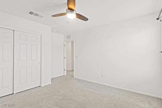 unfurnished bedroom featuring baseboards, a closet, visible vents, and carpet flooring