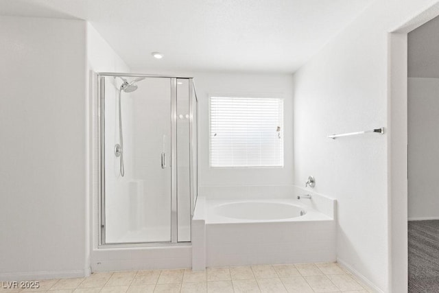 full bath with a garden tub, a shower stall, baseboards, and tile patterned floors