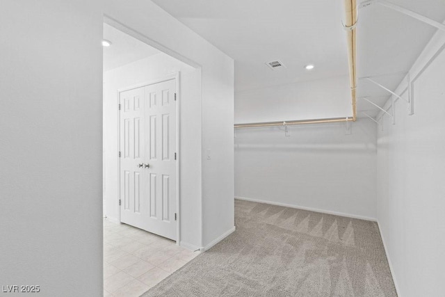 walk in closet featuring carpet and visible vents