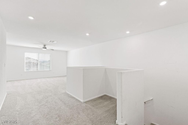 empty room with recessed lighting, visible vents, and light colored carpet