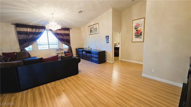 living room featuring a chandelier, visible vents, baseboards, vaulted ceiling, and light wood-style floors