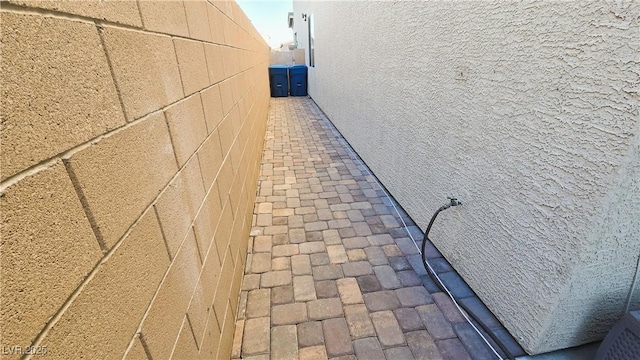 exterior space featuring fence and stucco siding