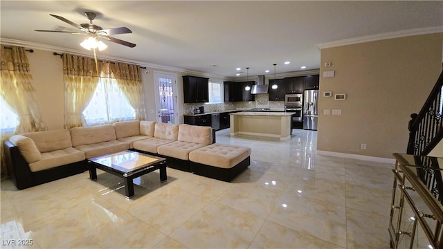 living room with ornamental molding, ceiling fan, baseboards, and stairs