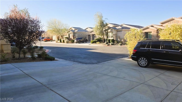 view of road featuring driveway and a residential view