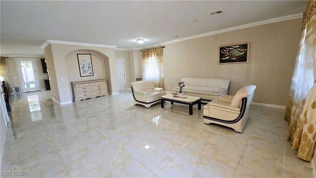 living room with a healthy amount of sunlight, visible vents, baseboards, and crown molding