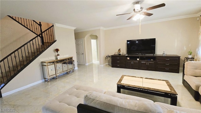 living room featuring stairway, baseboards, arched walkways, and ornamental molding