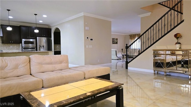 living area featuring arched walkways, marble finish floor, crown molding, stairway, and baseboards