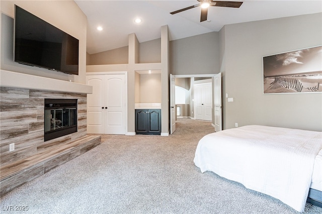 carpeted bedroom with recessed lighting, ceiling fan, high vaulted ceiling, a tile fireplace, and baseboards