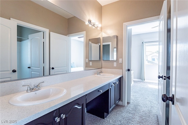 bathroom with a sink, baseboards, and double vanity