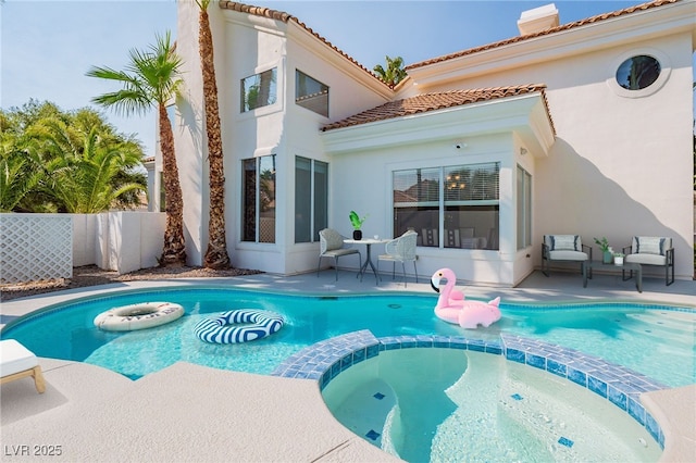 view of swimming pool featuring a pool with connected hot tub