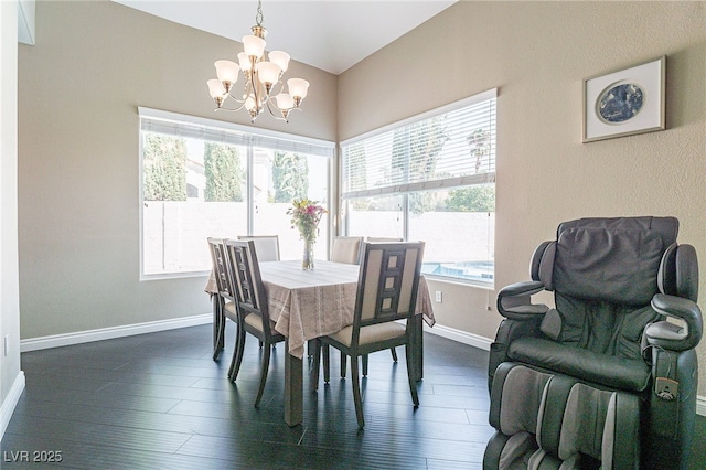 dining space with lofted ceiling, baseboards, dark wood finished floors, and a notable chandelier