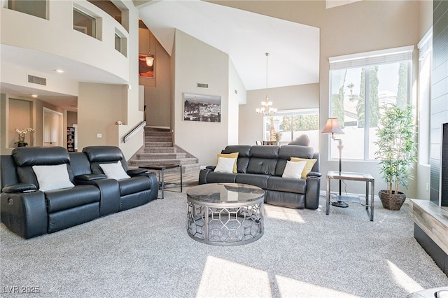 living area featuring carpet, visible vents, stairway, an inviting chandelier, and high vaulted ceiling